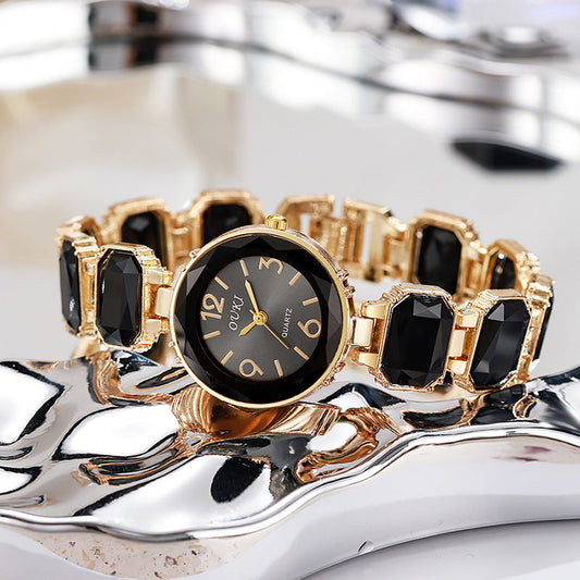 Damen Quarzarmbanduhr mit goldfarbenem Armband und schwarzem Kristallzifferblatt